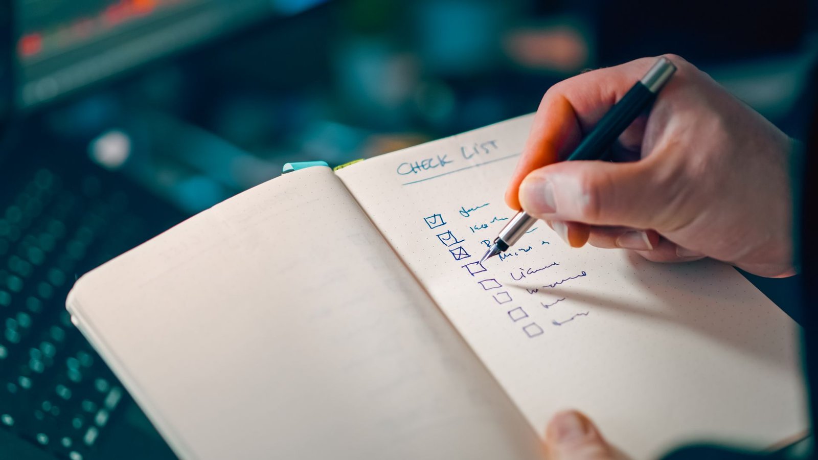 A checklist in a notebook with a pen