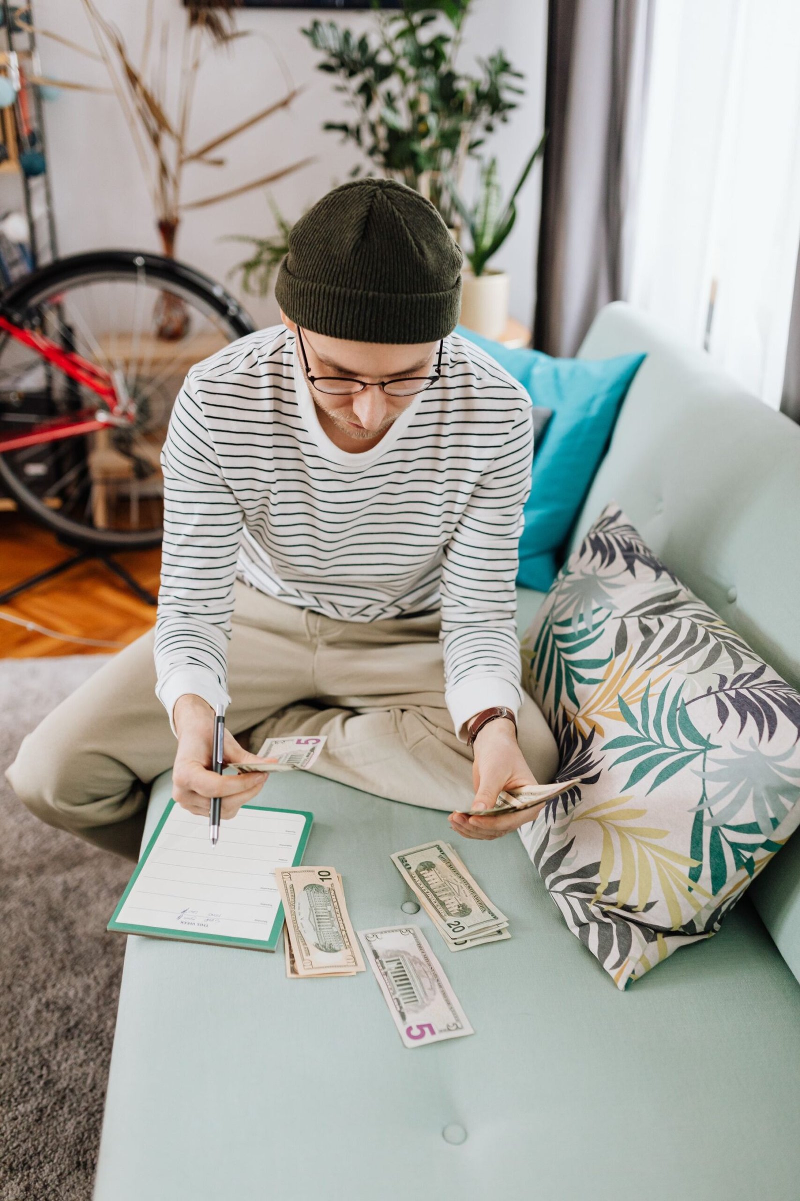 A person budgeting money at home
