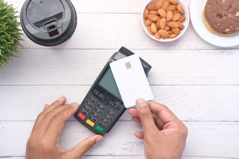 A hand holding a credit card