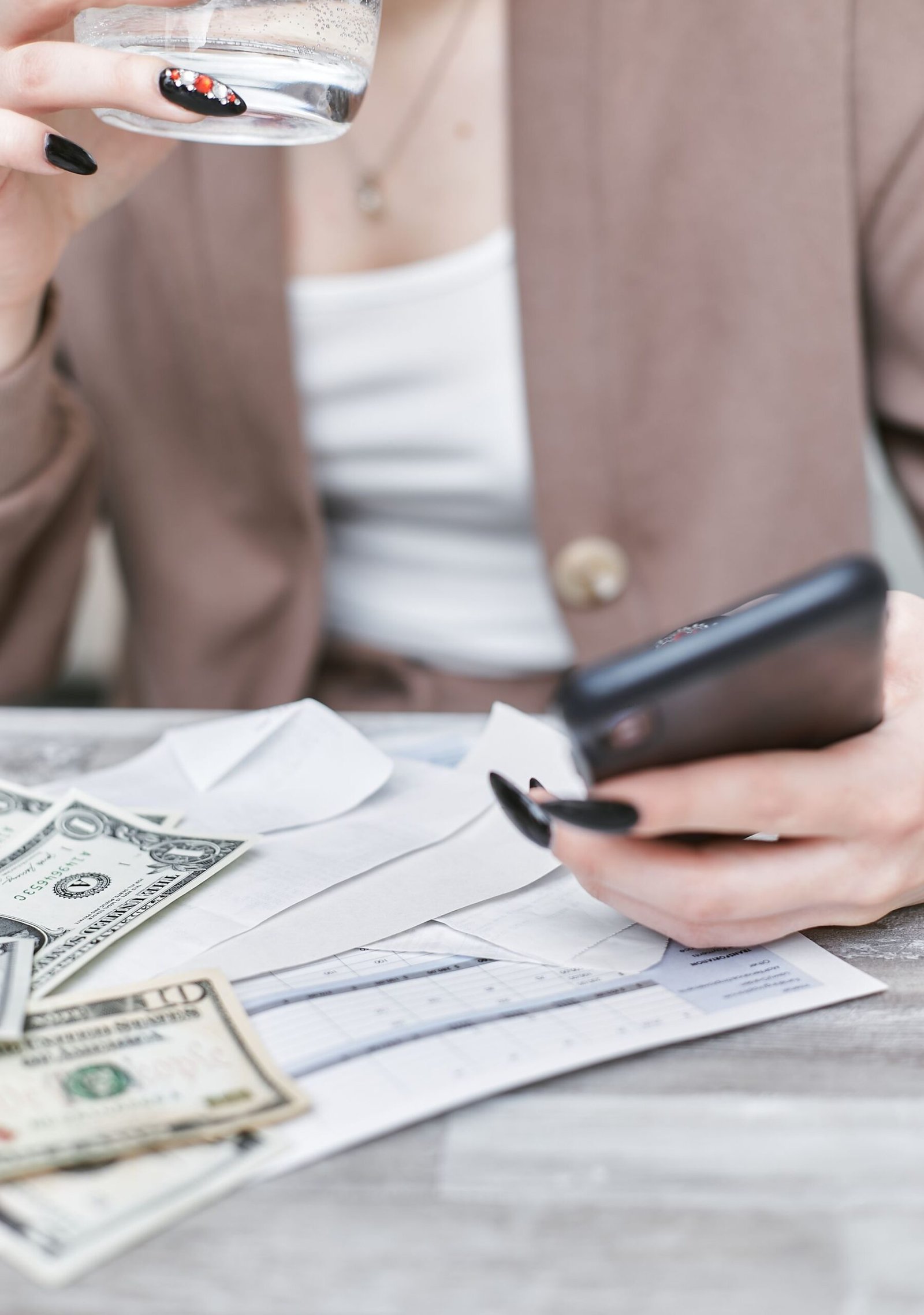 A young adult budgeting with a smartphone