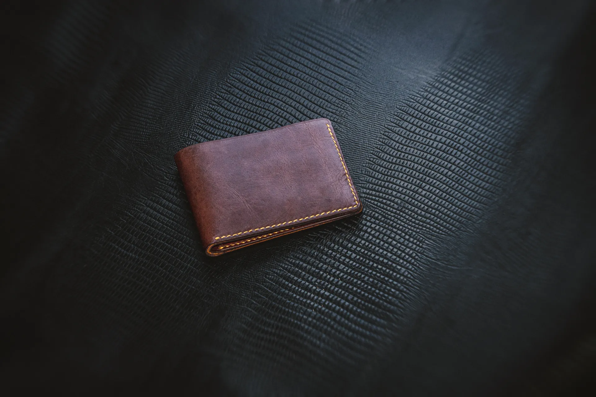 Minimalist Brown Leather Wallet on Textured Background