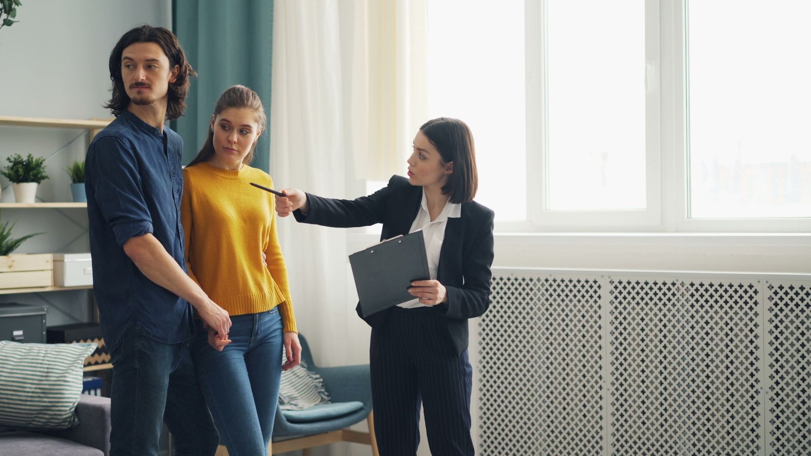 Real estate agent showing a house to a couple