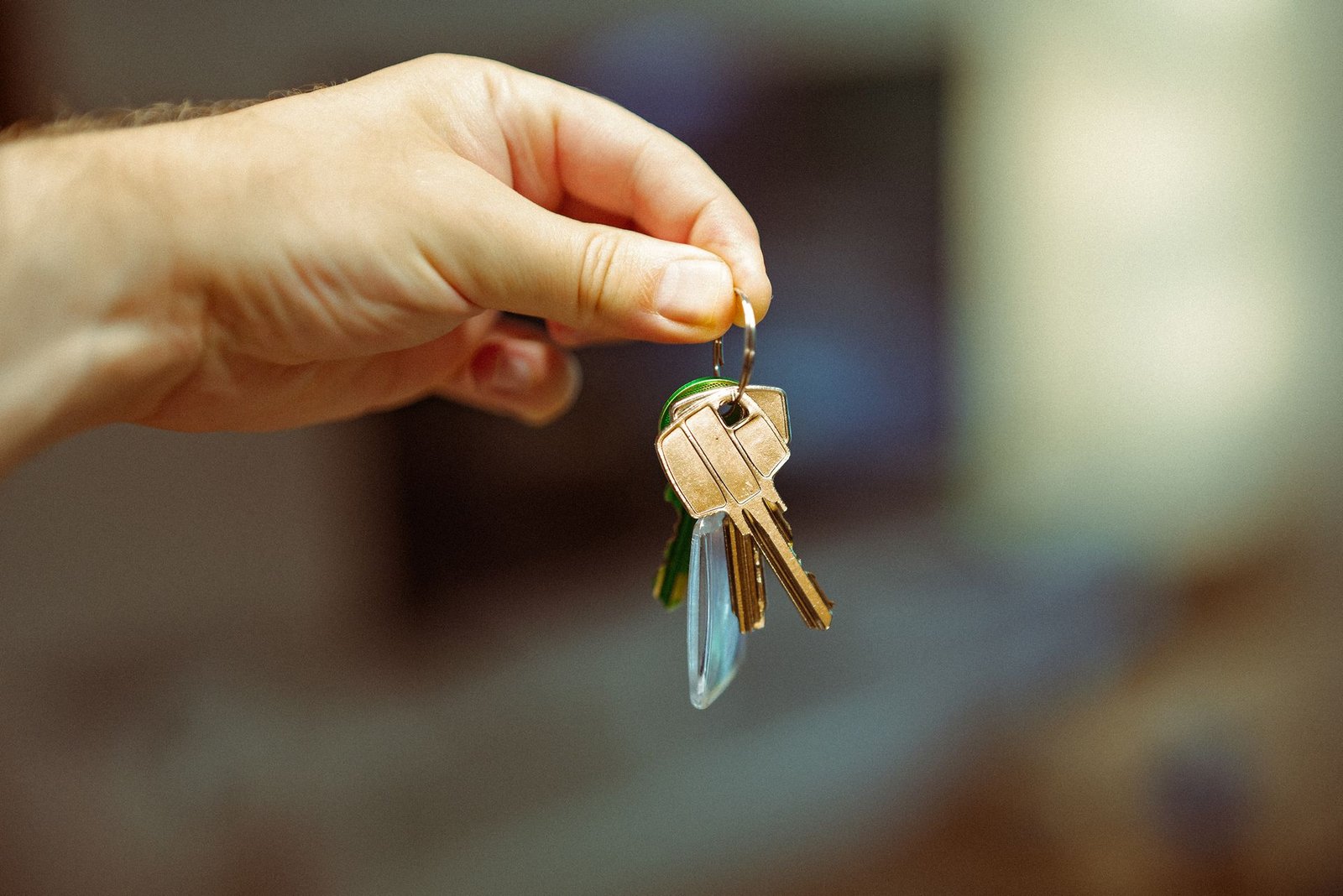 Hand holding house keys close up
