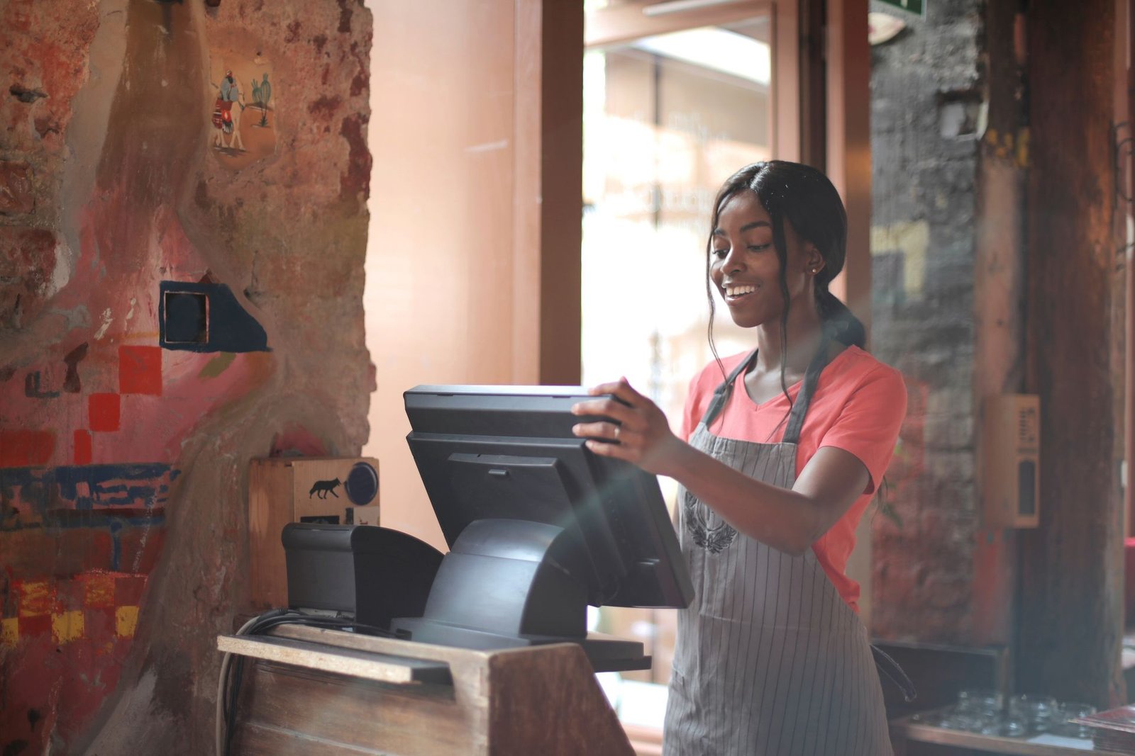 Cashier at a store counter handling payment