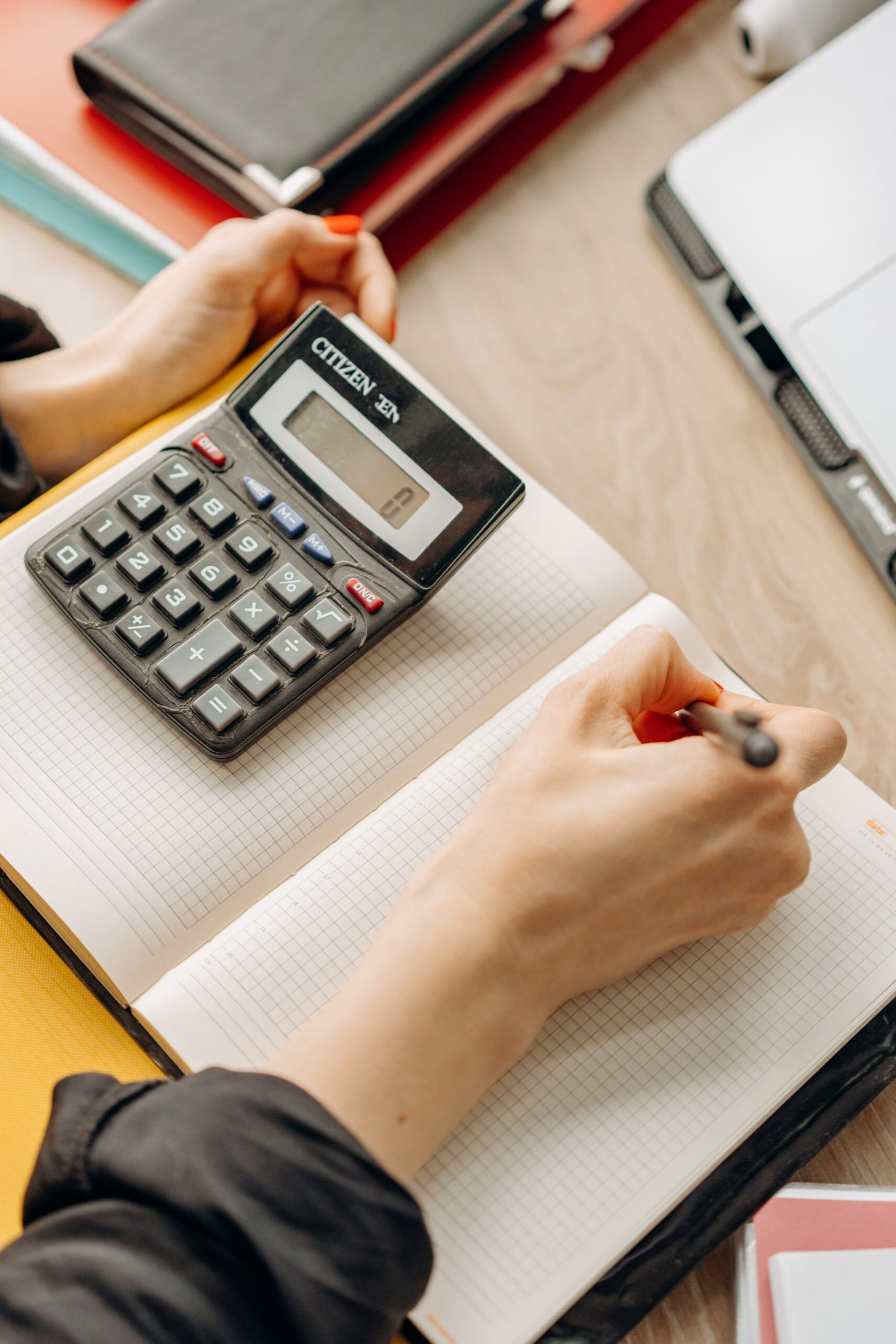 Woman computing with a calculator