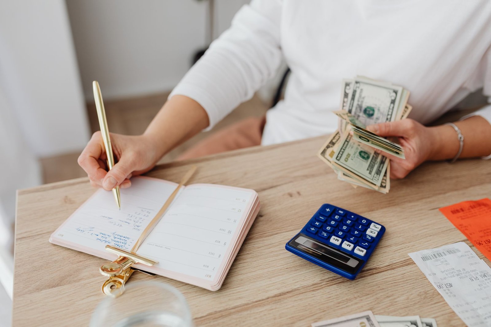 A notebook with financial planning and a pen
