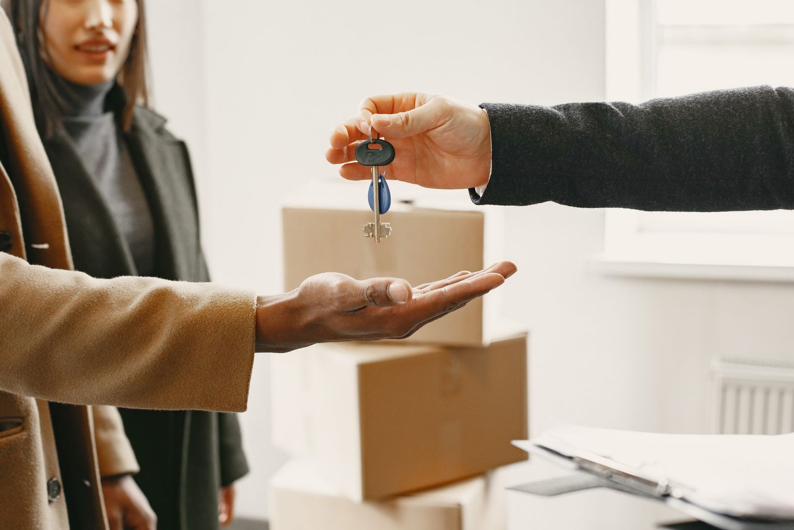 Person giving house keys to a family
