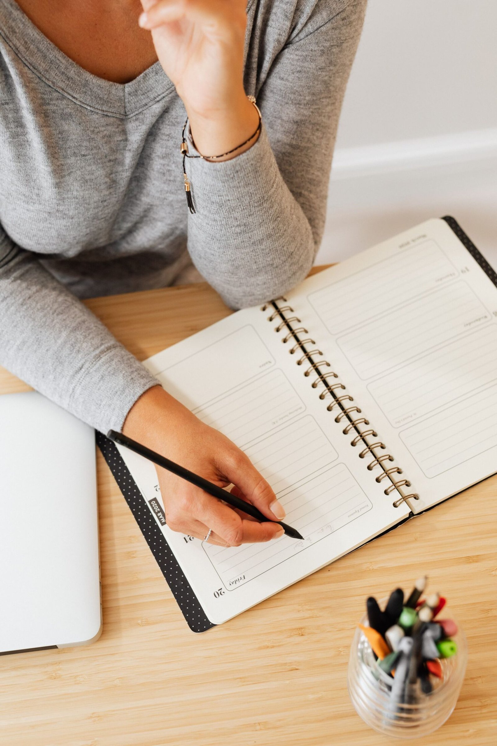 Person writing notes while planning