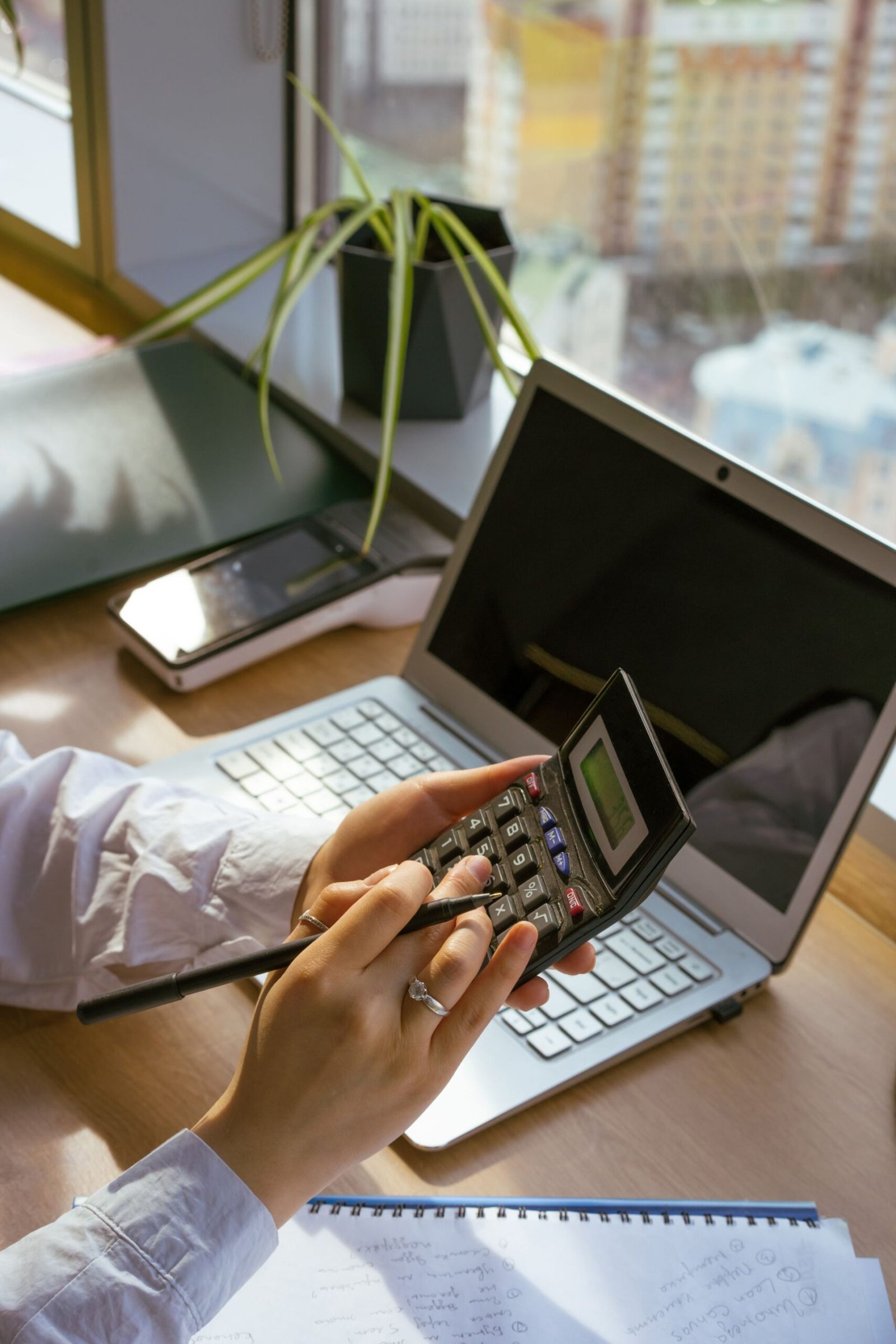 Calculator and laptop on a business desk