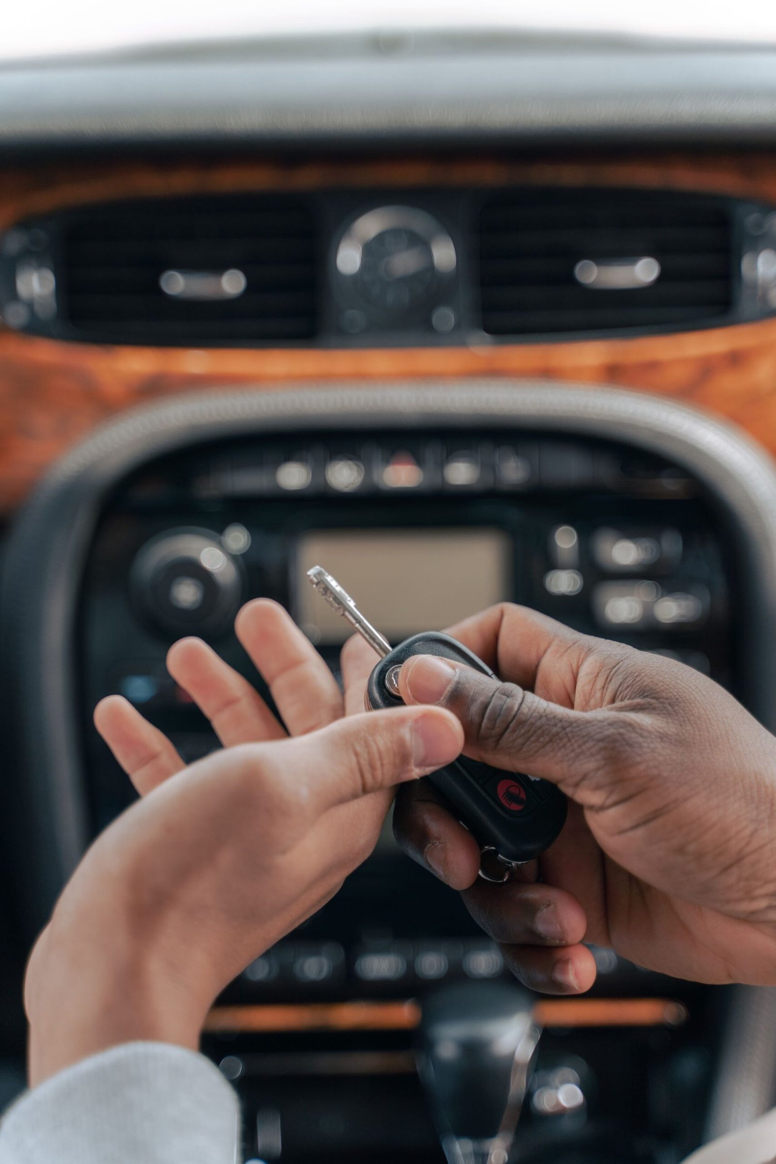 Car keys being handed over inside a vehicle