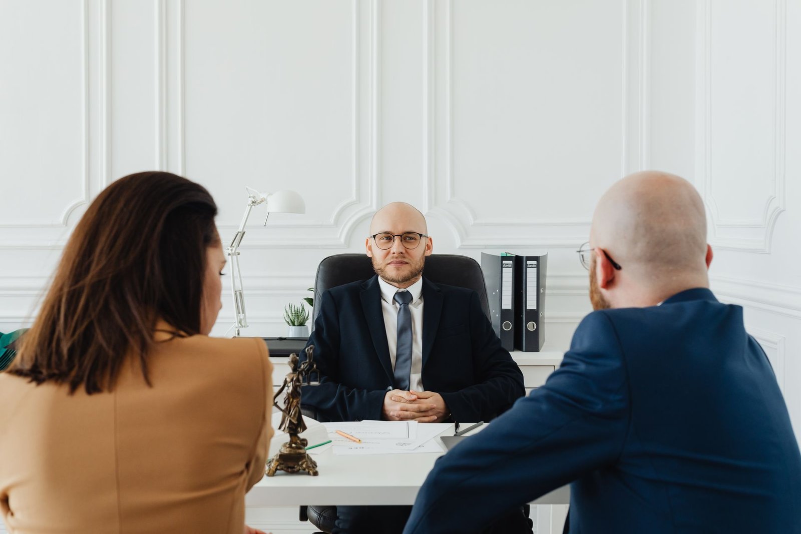 Borrower meeting with a loan officer at a desk