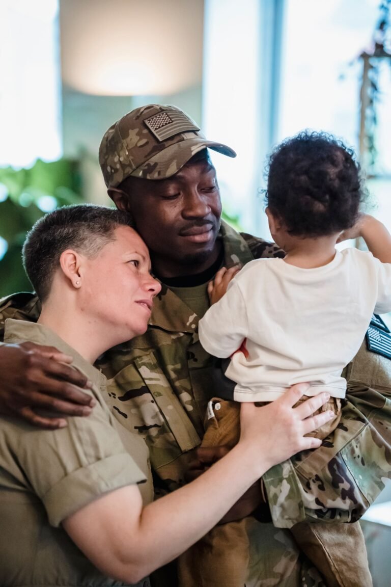 U.S. soldier in camouflage uniform embracing his family at home
