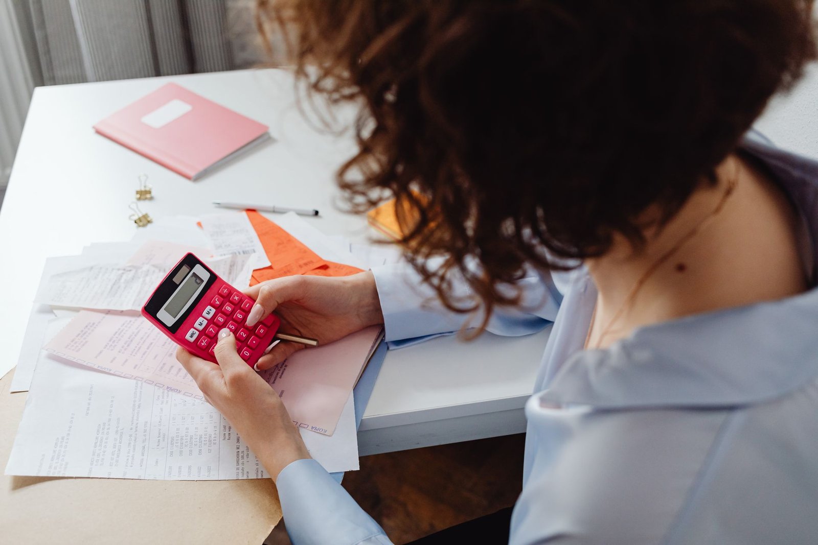 Calculator and stacked bills on a desk during financial planning