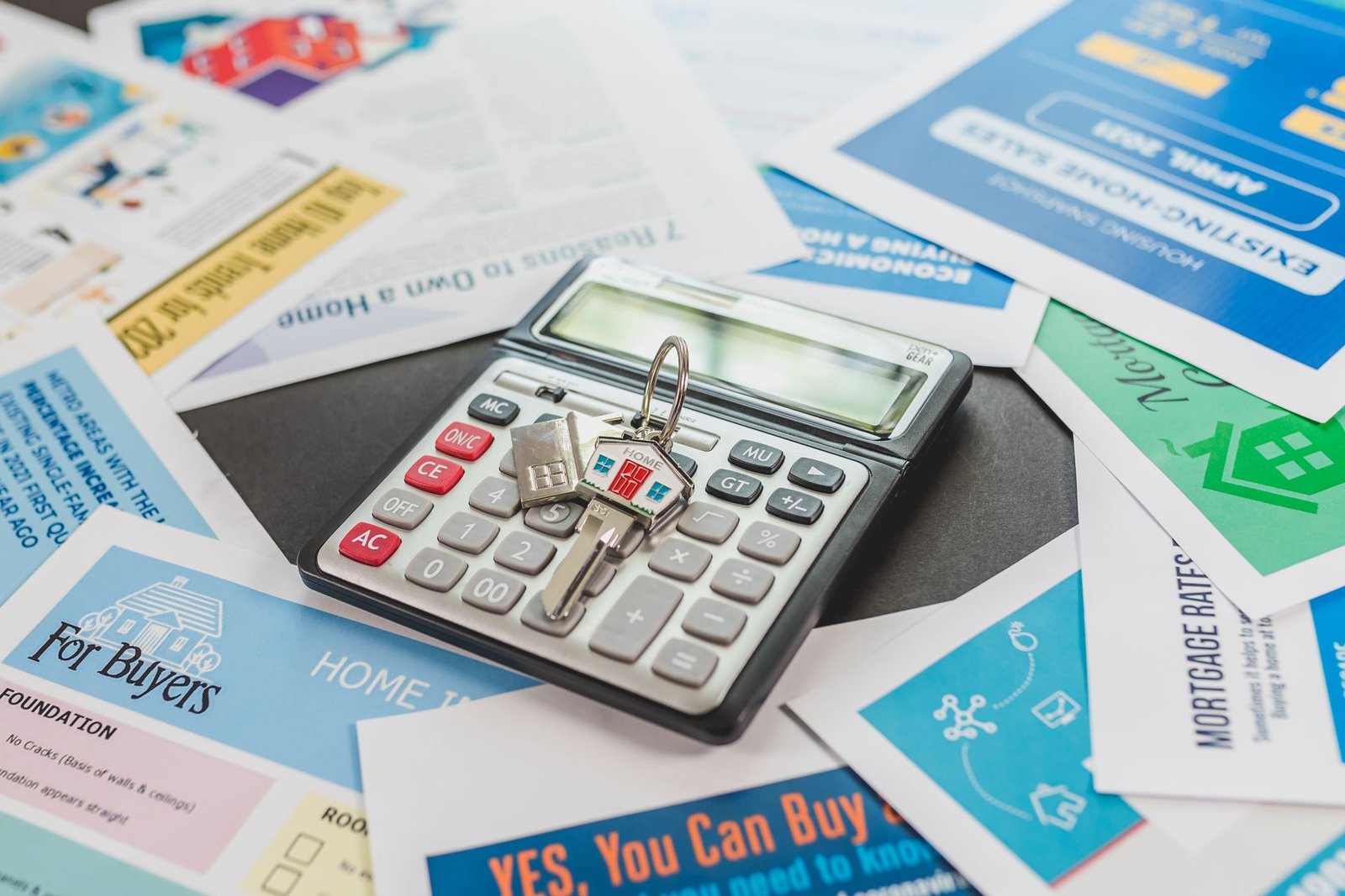 House model beside a calculator for borrowing math