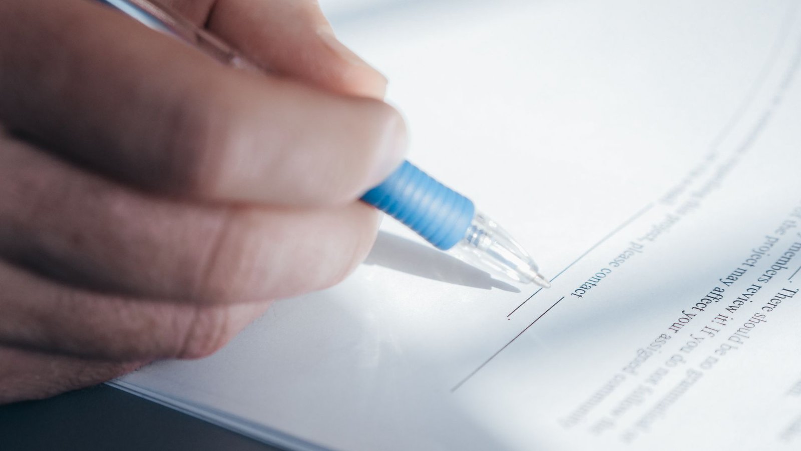 Close-up of signing a contract with a pen