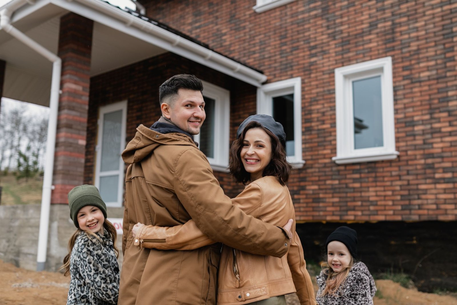 A family in front of their new house