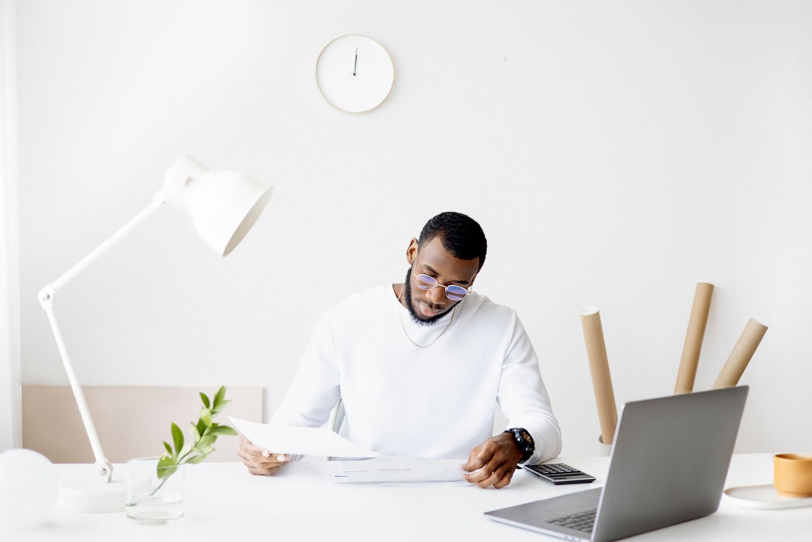 A person reviewing financial documents on a laptop